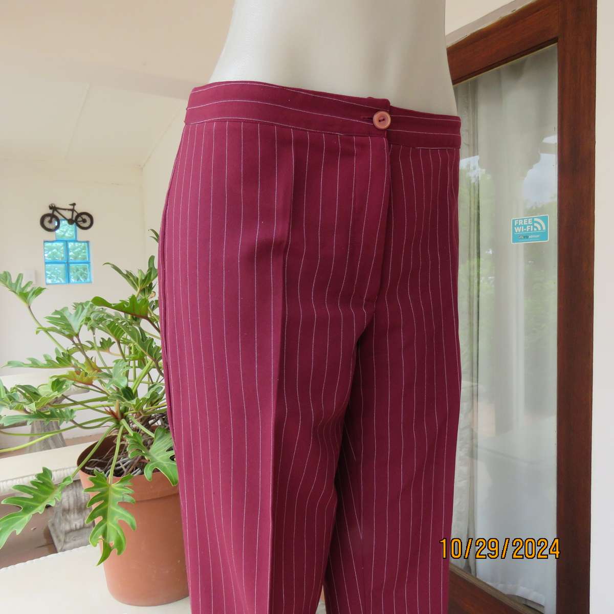 Classic maroon-white pinstripe 2 pc pantsuit. In 100% polyester. Tailored 1 button jacket. Size 40.