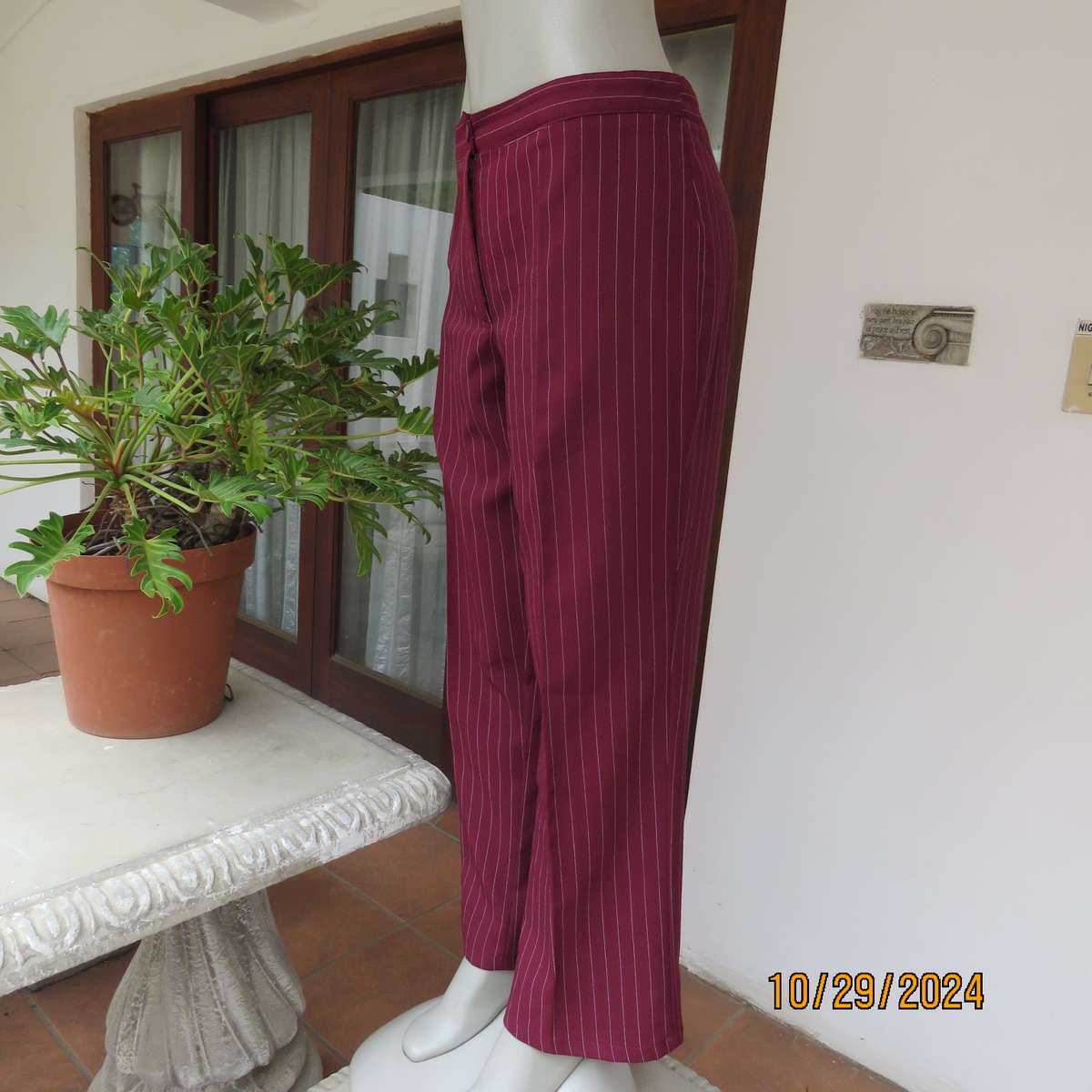 Classic maroon-white pinstripe 2 pc pantsuit. In 100% polyester. Tailored 1 button jacket. Size 40.
