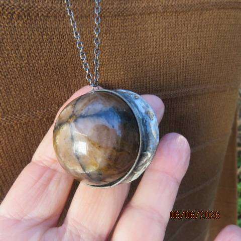 Chiastolite cross stone sphere pendant with metal band and chain