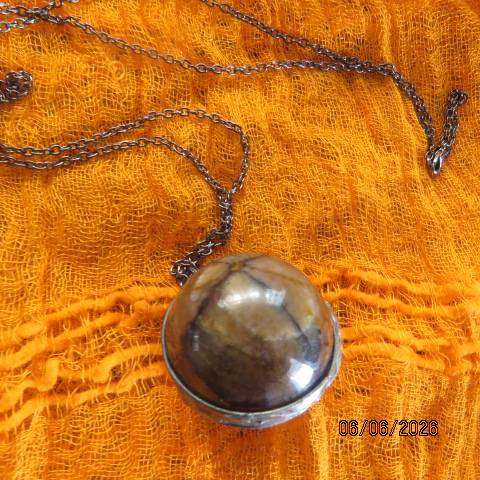 Chiastolite cross stone sphere pendant with metal band and chain