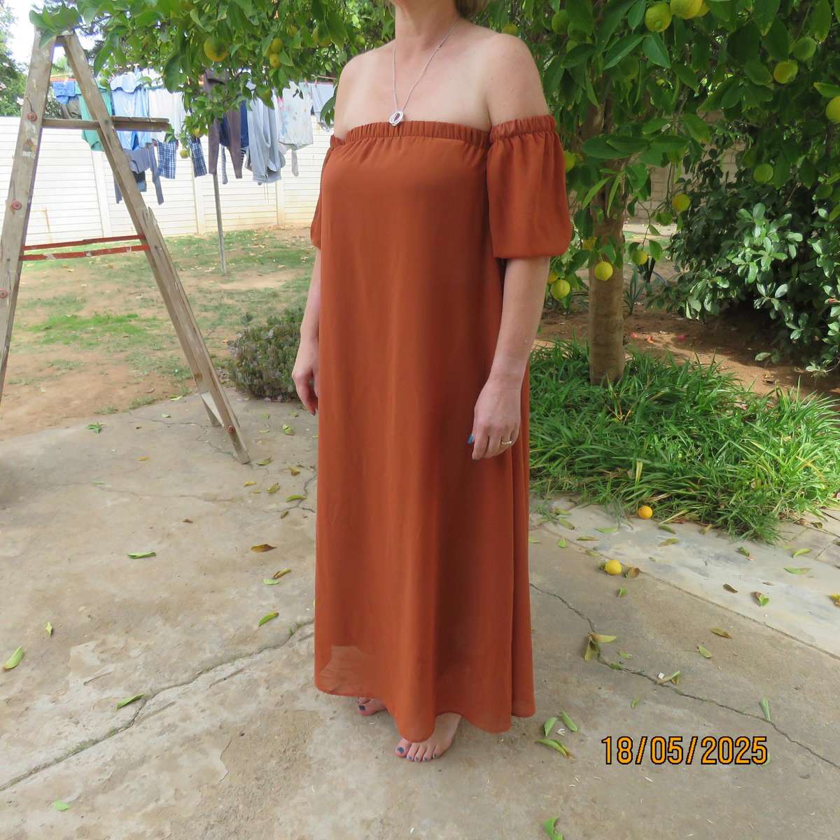 NEW FEELING rust colour loose hanging lined sheer polyester strapless dress. Size 34