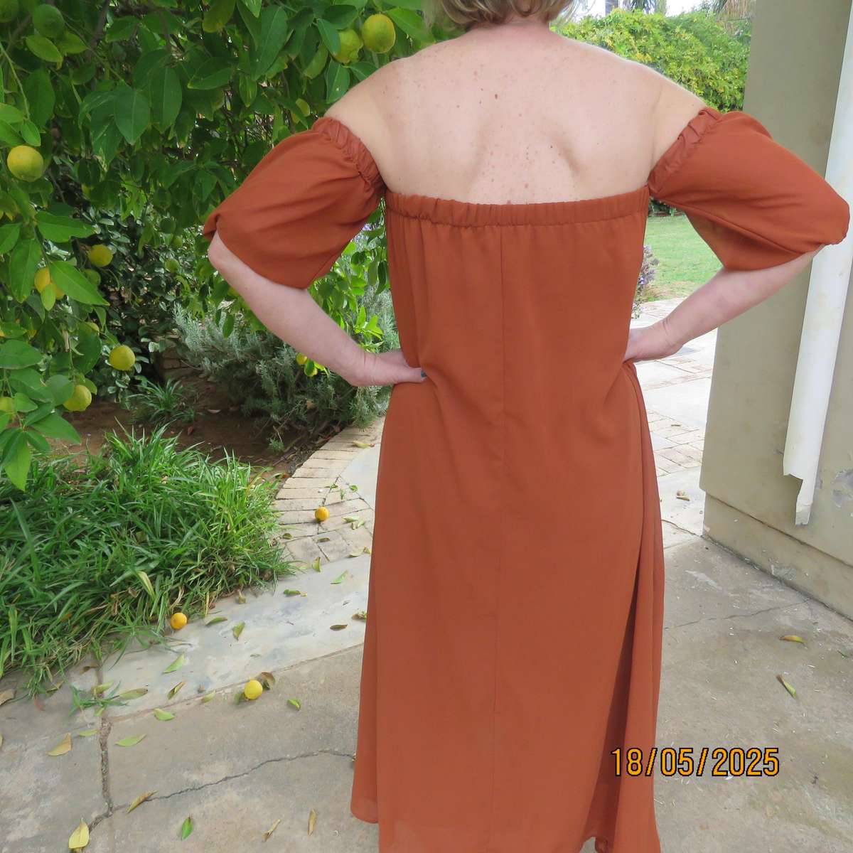 NEW FEELING rust colour loose hanging lined sheer polyester strapless dress. Size 34