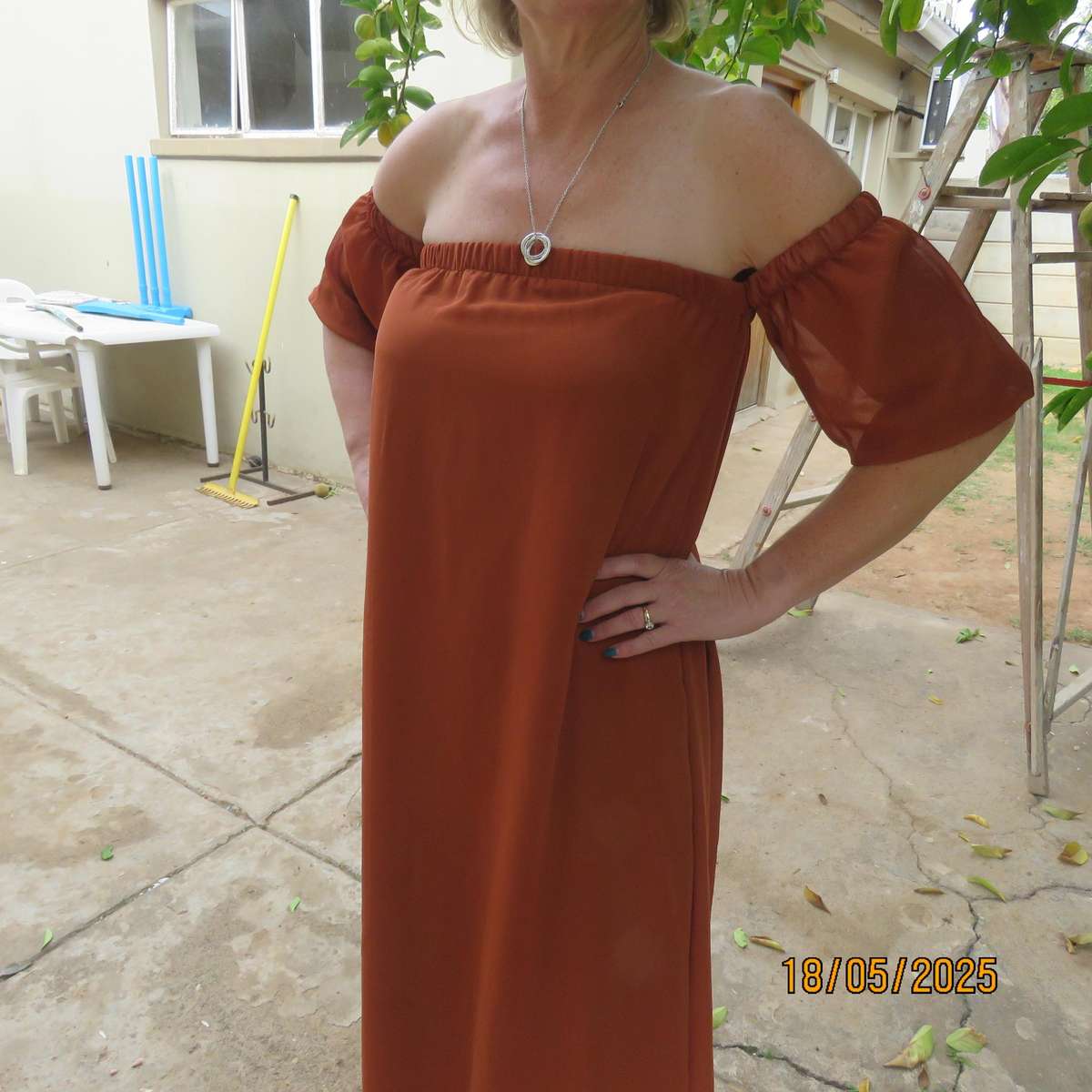 NEW FEELING rust colour loose hanging lined sheer polyester strapless dress. Size 34