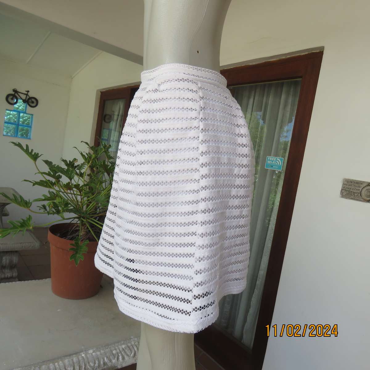 White 2 layer polyester lace knee length skirt size 36. With few knife pleats.