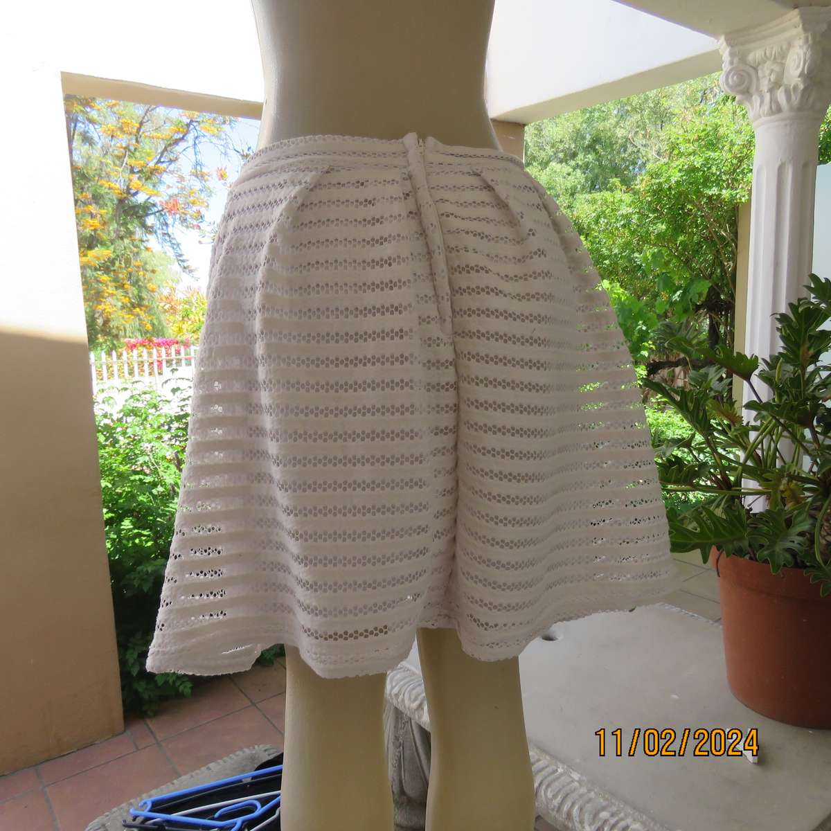 White 2 layer polyester lace knee length skirt size 36. With few knife pleats.