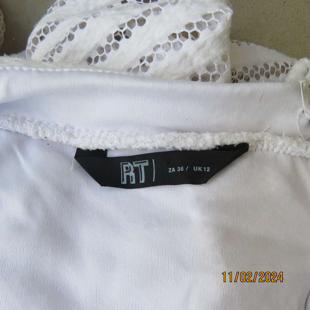 White 2 layer polyester lace knee length skirt size 36. With few knife pleats.