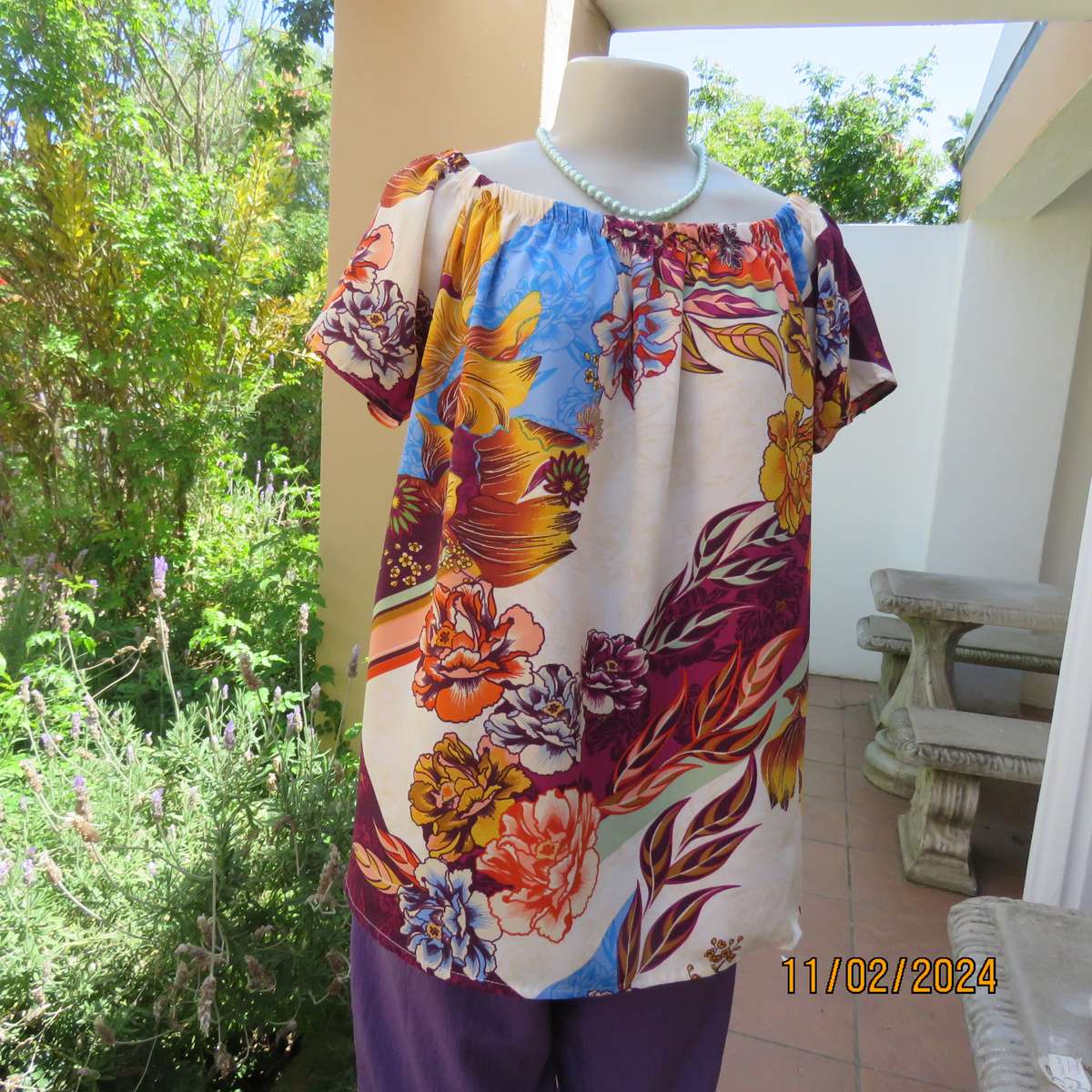 Easy to wear OR size 40-42 slip over off the shoulder top in cream-purple-blue-orange flowers.As new