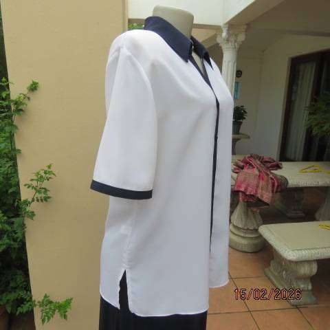 WOOLWORTHS white polyester short sleeve button down top with navy collar and trims. Size 38-40