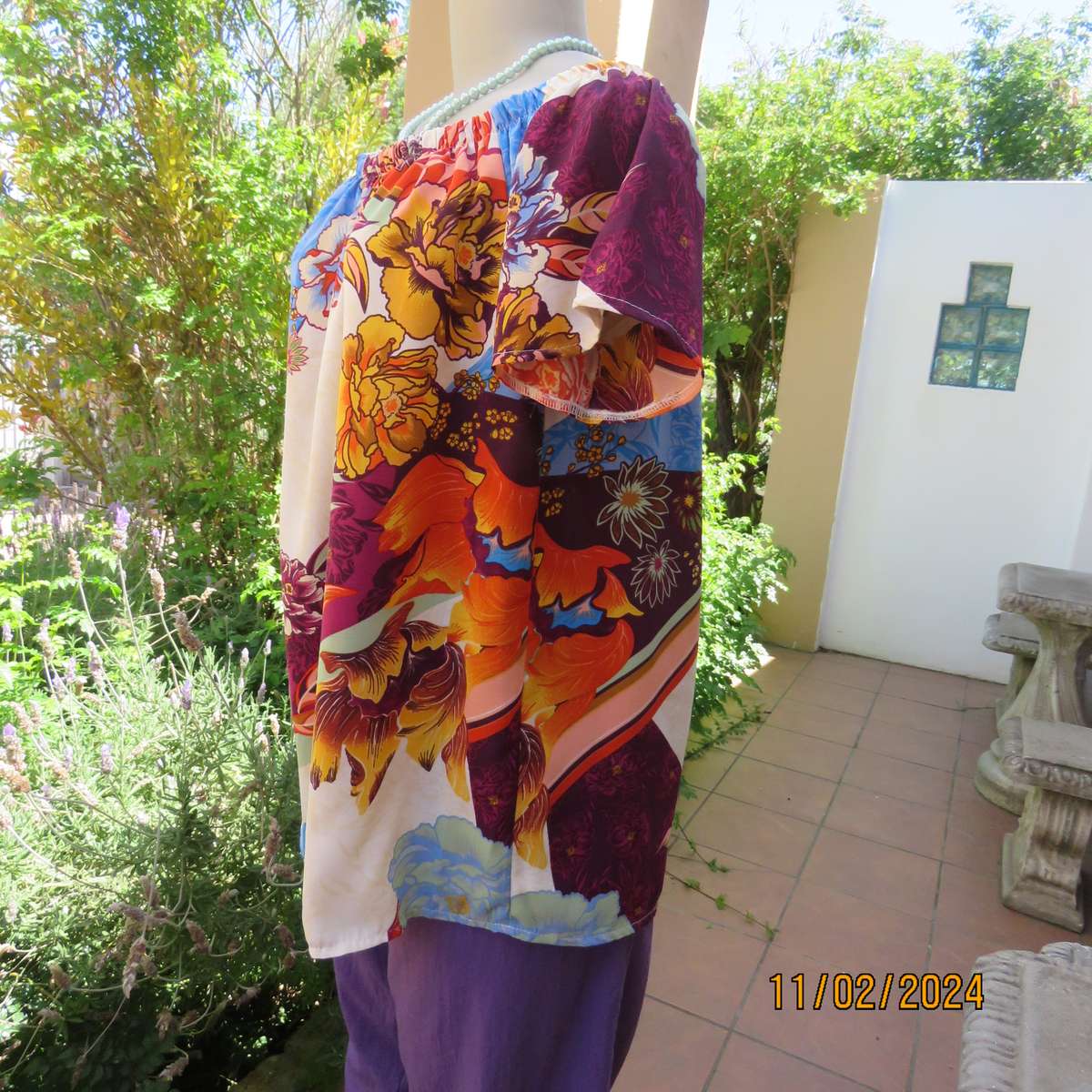 Easy to wear OR size 40-42 slip over off the shoulder top in cream-purple-blue-orange flowers.As new
