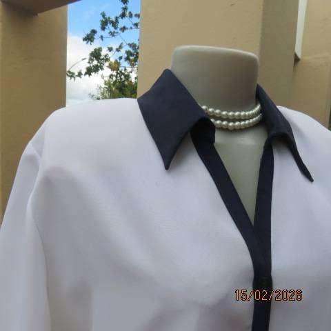 WOOLWORTHS white polyester short sleeve button down top with navy collar and trims. Size 38-40