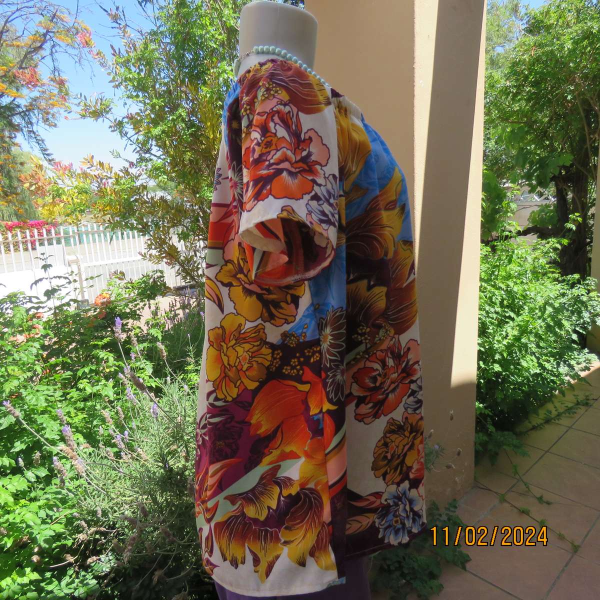 Easy to wear OR size 40-42 slip over off the shoulder top in cream-purple-blue-orange flowers.As new