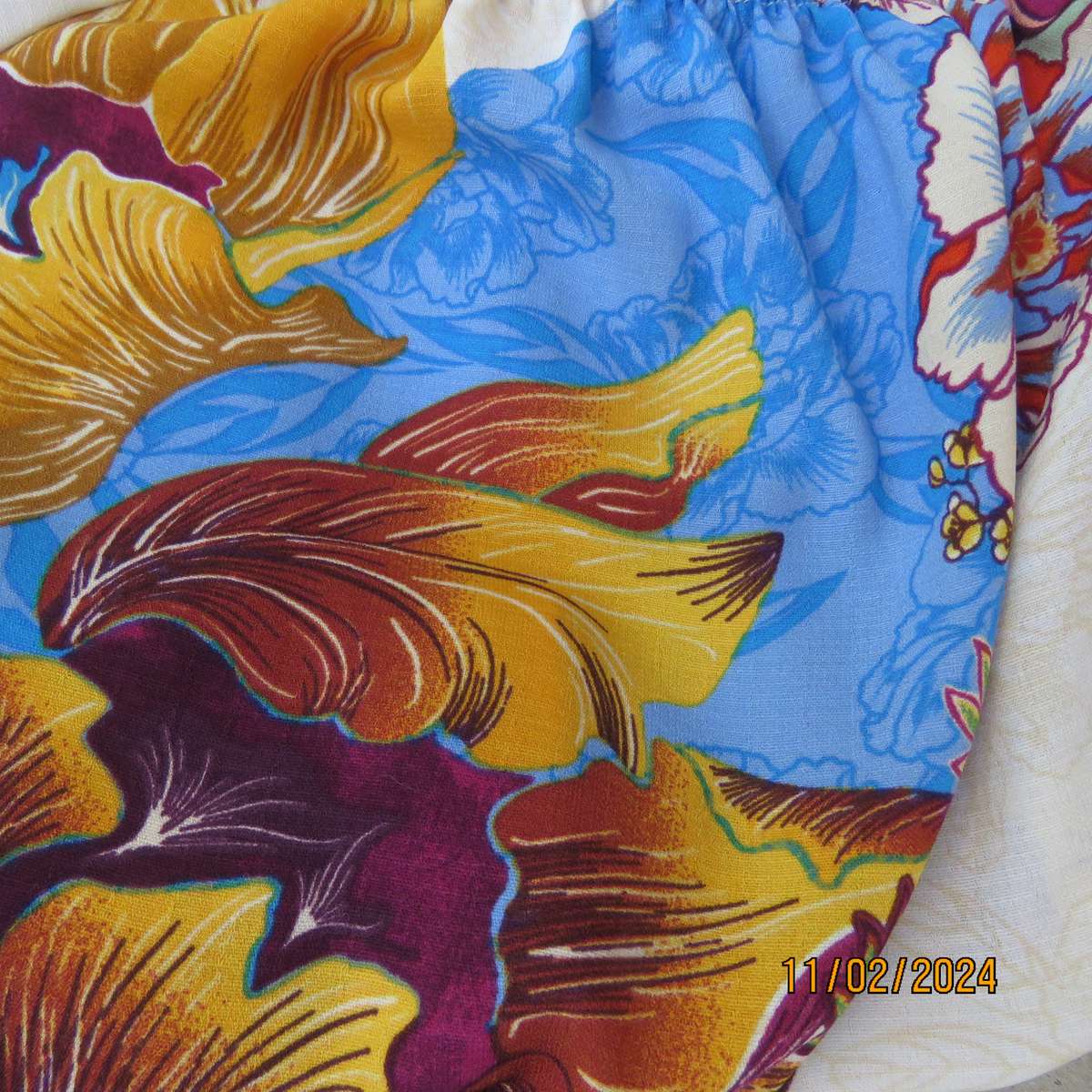 Easy to wear OR size 40-42 slip over off the shoulder top in cream-purple-blue-orange flowers.As new