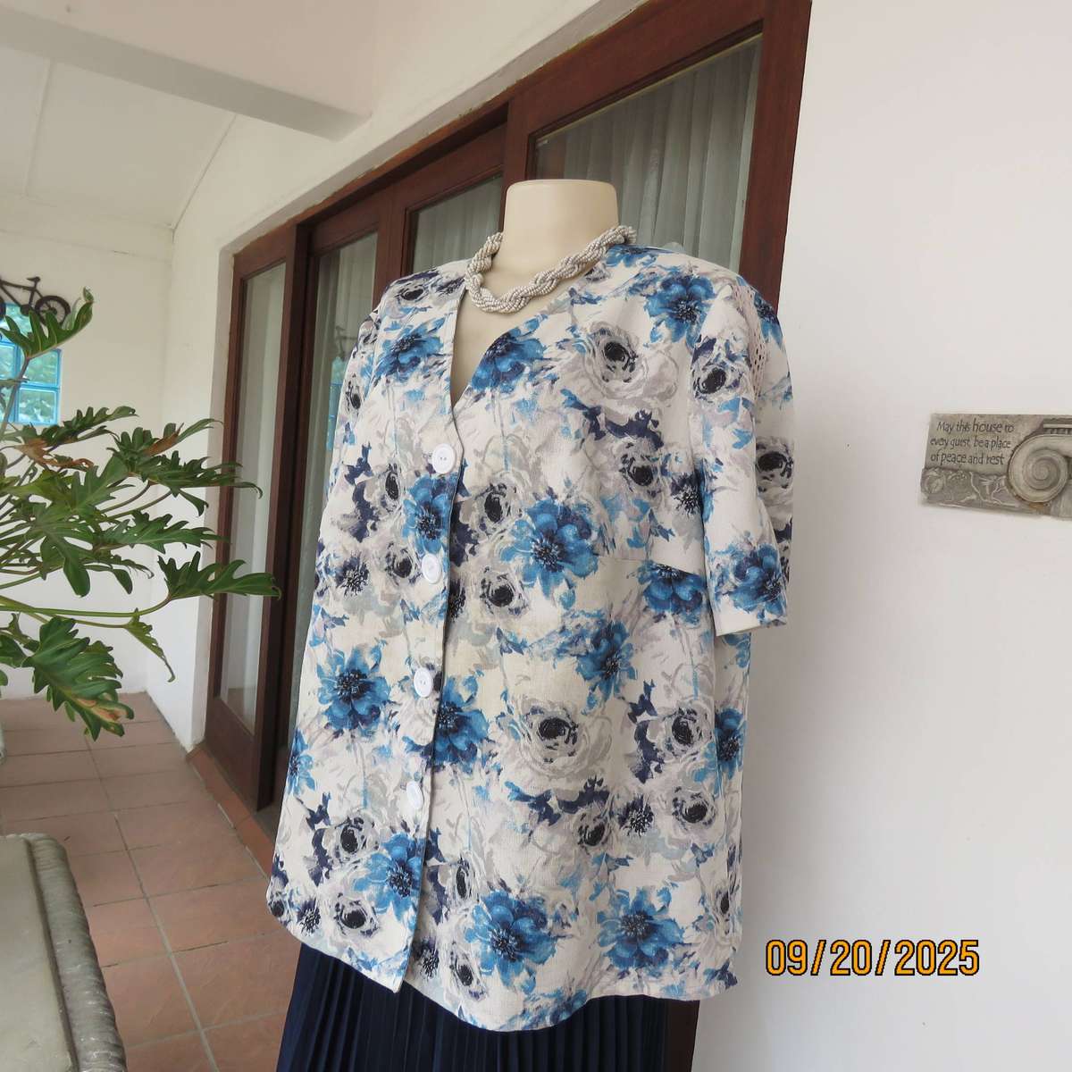 Boutique made white woven polycotton top with blue-grey flowers. Short sleeves. Size 44