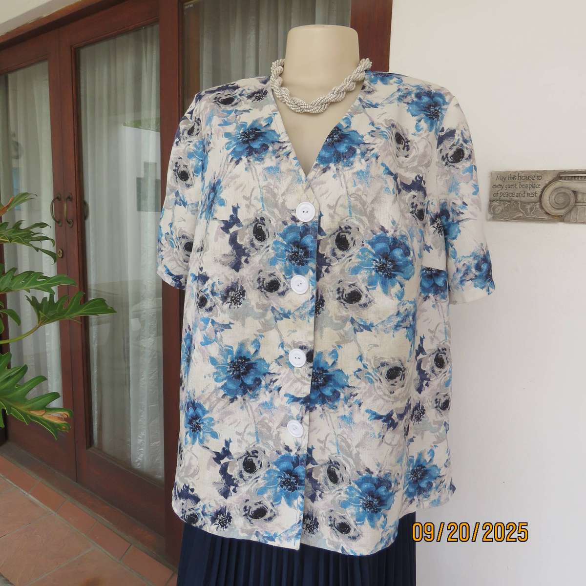 Boutique made white woven polycotton top with blue-grey flowers. Short sleeves. Size 44