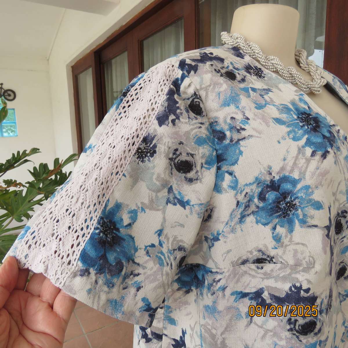 Boutique made white woven polycotton top with blue-grey flowers. Short sleeves. Size 44