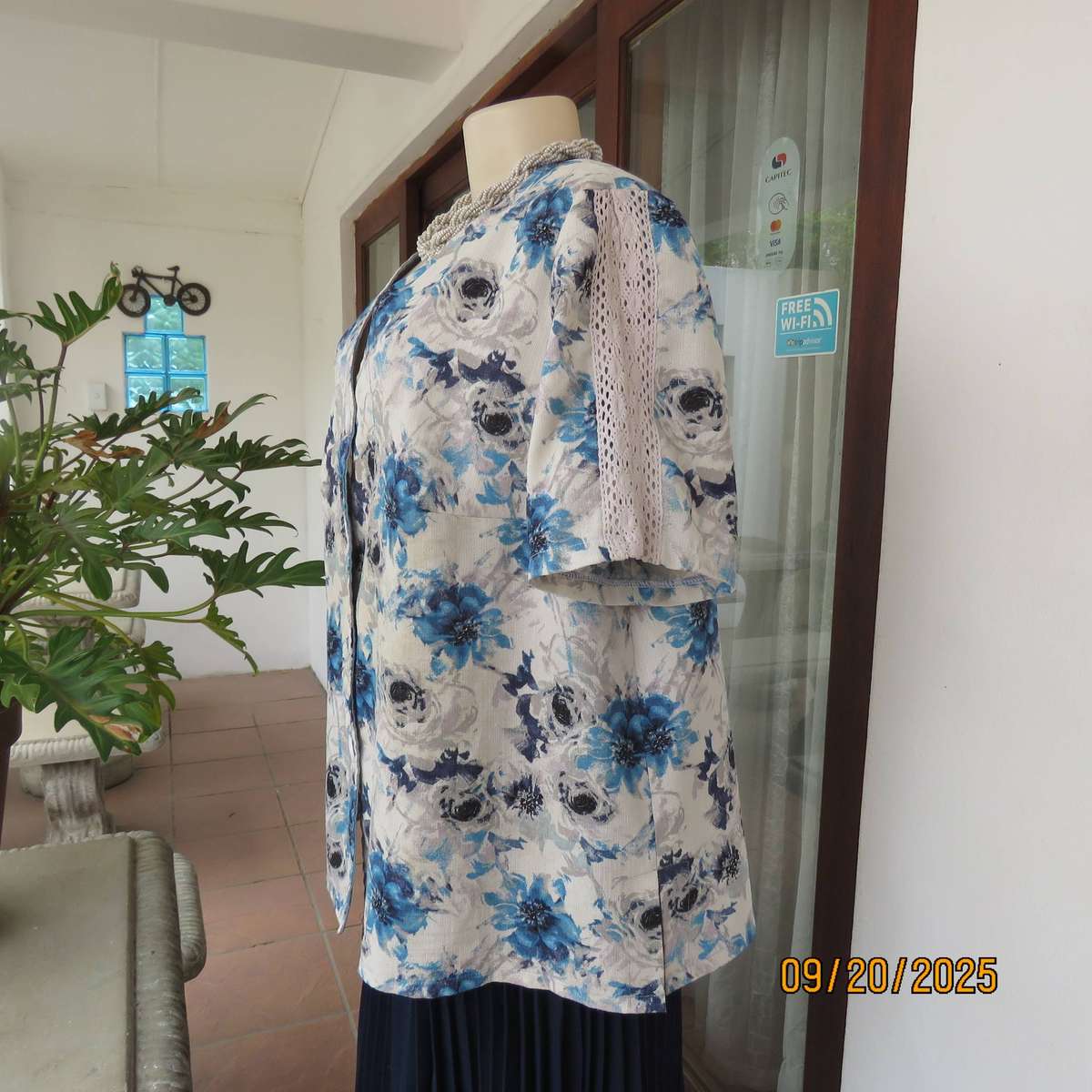 Boutique made white woven polycotton top with blue-grey flowers. Short sleeves. Size 44