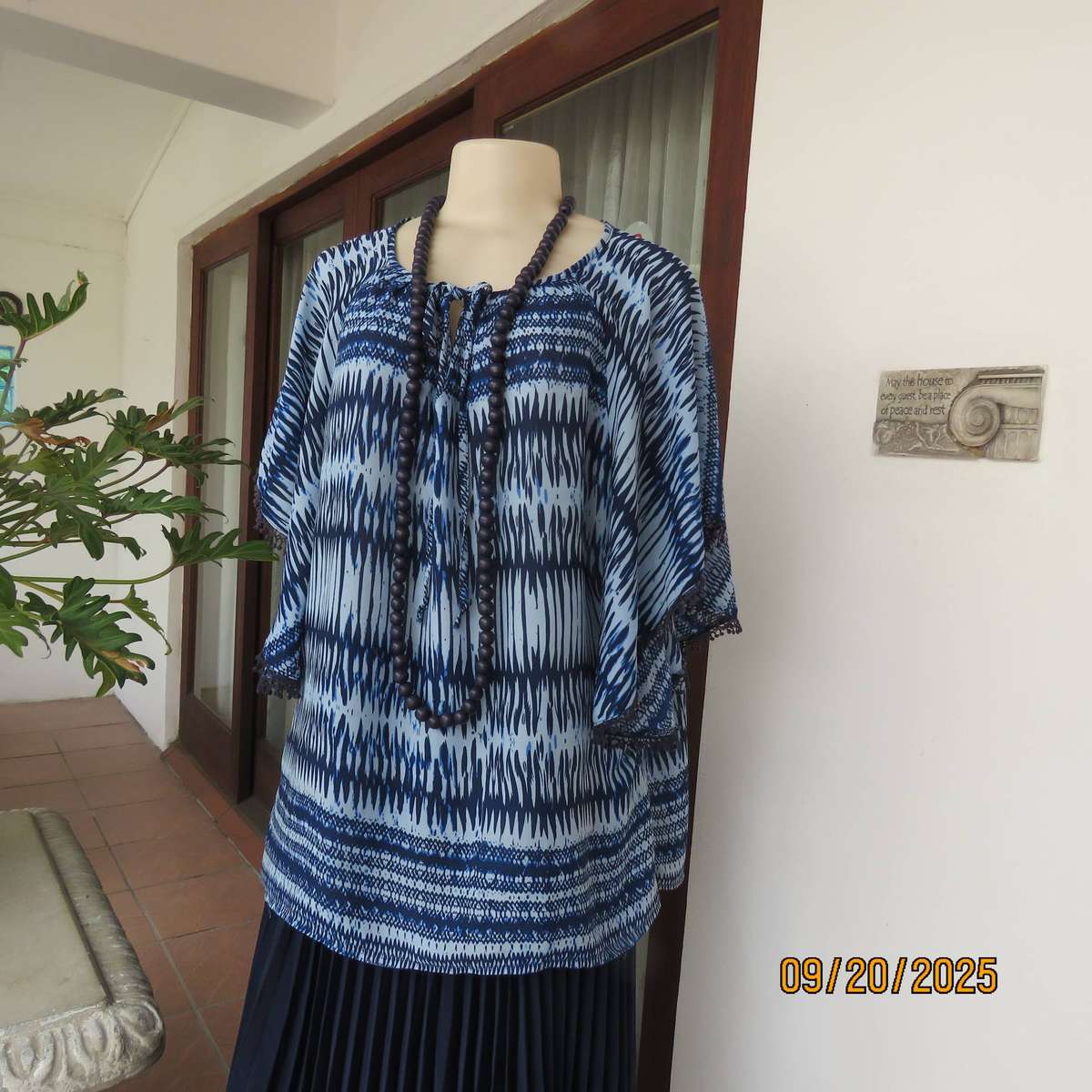 Horizontal patterned slip over top in medley of blues. Wide short raglan sleeves. Size 40