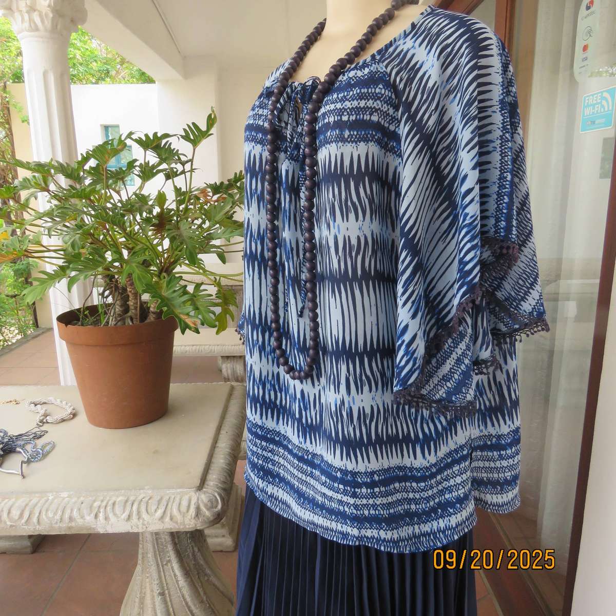 Horizontal patterned slip over top in medley of blues. Wide short raglan sleeves. Size 40
