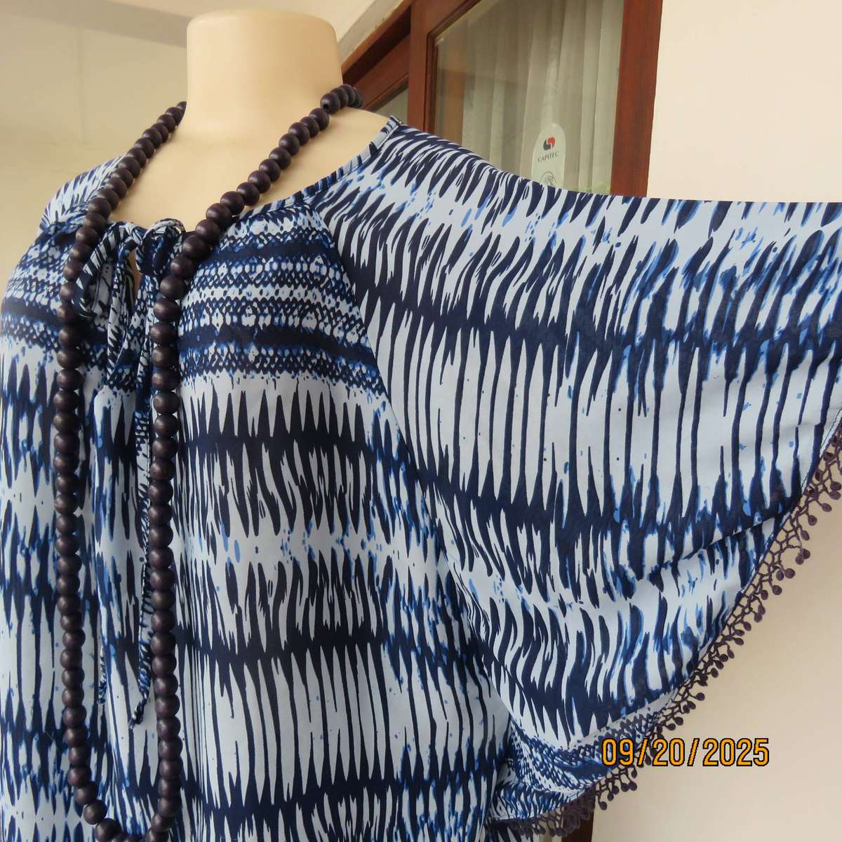 Horizontal patterned slip over top in medley of blues. Wide short raglan sleeves. Size 40