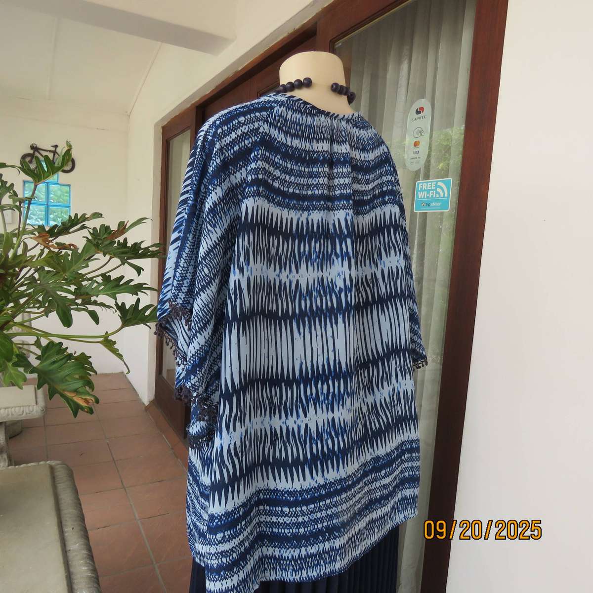 Horizontal patterned slip over top in medley of blues. Wide short raglan sleeves. Size 40