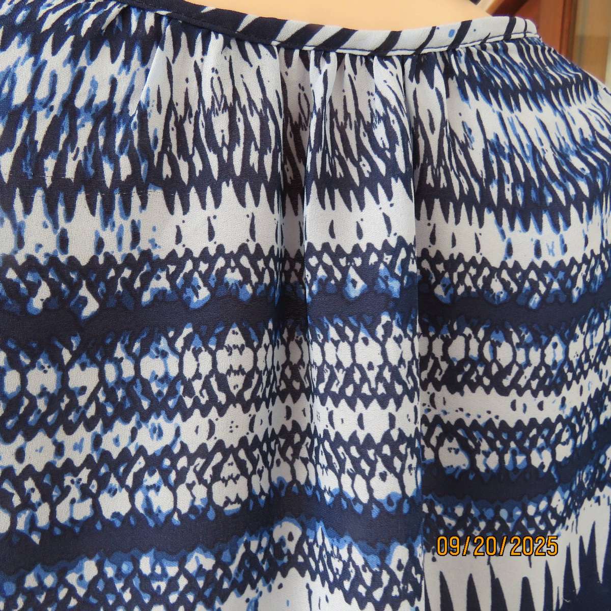 Horizontal patterned slip over top in medley of blues. Wide short raglan sleeves. Size 40