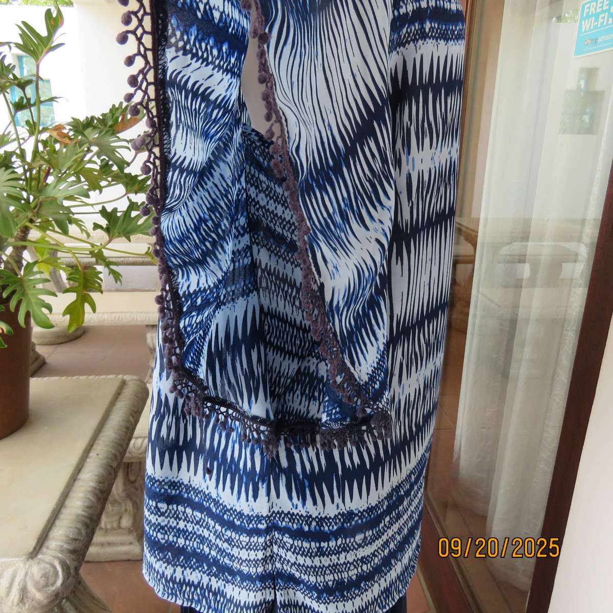 Horizontal patterned slip over top in medley of blues. Wide short raglan sleeves. Size 40