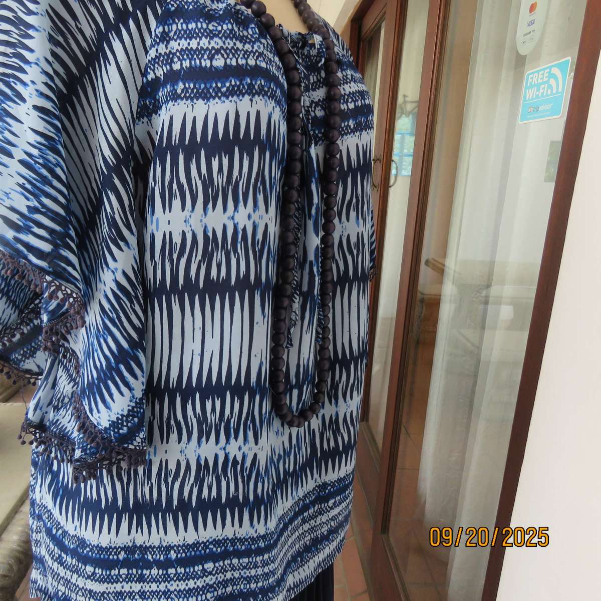 Horizontal patterned slip over top in medley of blues. Wide short raglan sleeves. Size 40