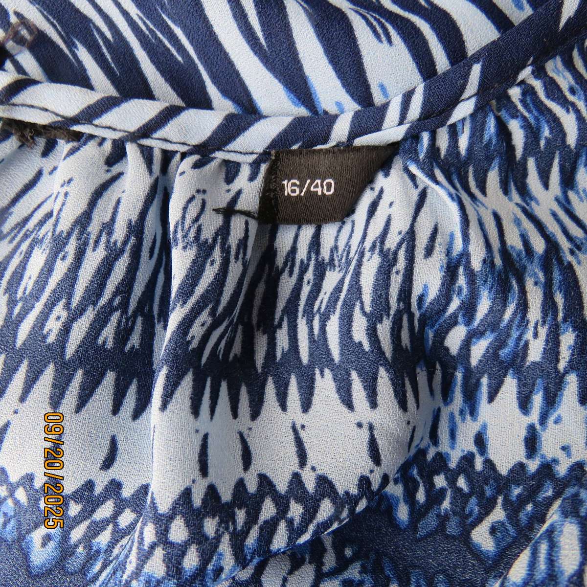 Horizontal patterned slip over top in medley of blues. Wide short raglan sleeves. Size 40