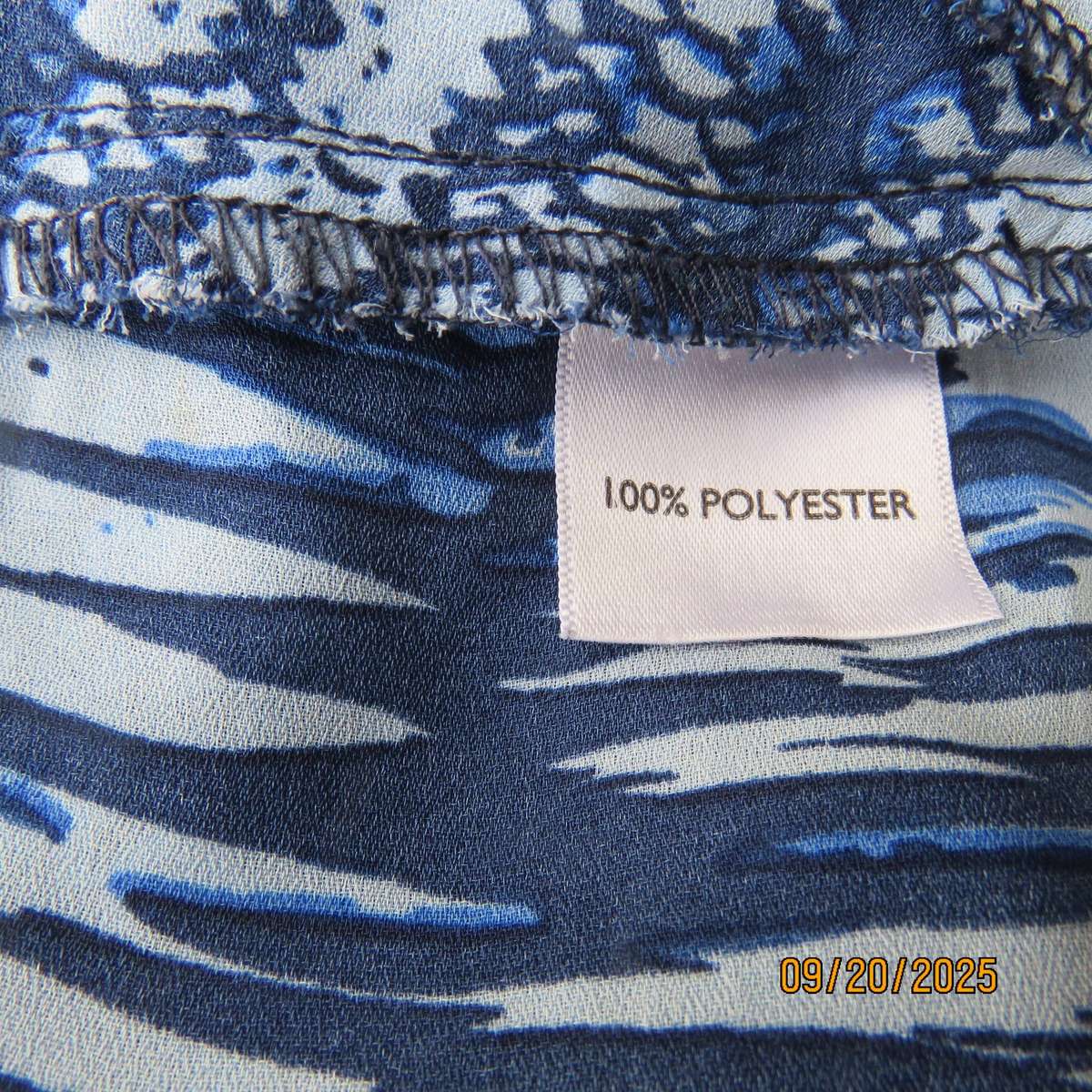Horizontal patterned slip over top in medley of blues. Wide short raglan sleeves. Size 40