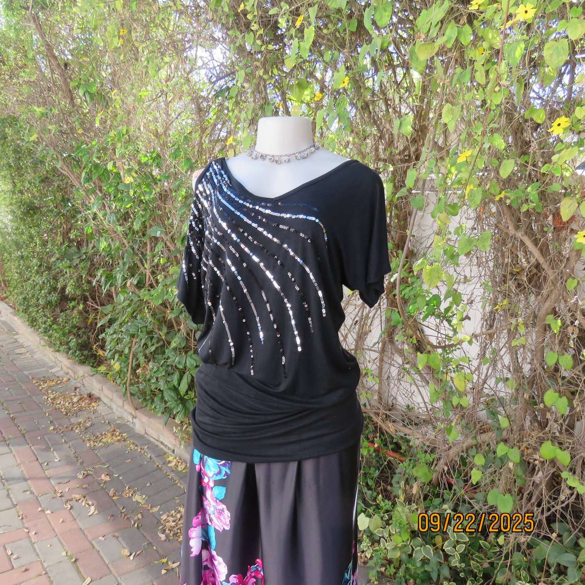 Black slip over glam top. Cut-on short sleeves. One open shoulder. Sequin decoration. Size 36