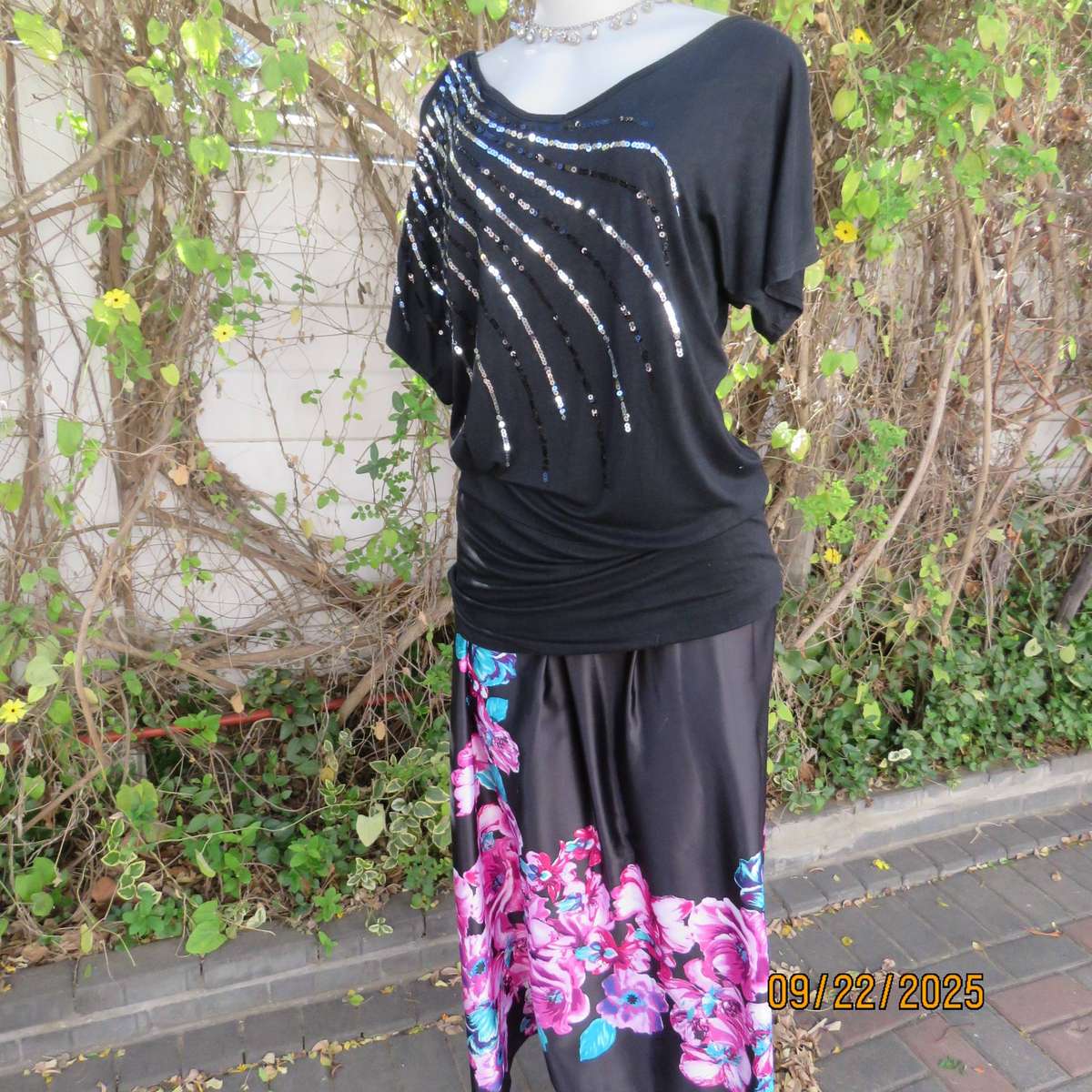Black slip over glam top. Cut-on short sleeves. One open shoulder. Sequin decoration. Size 36