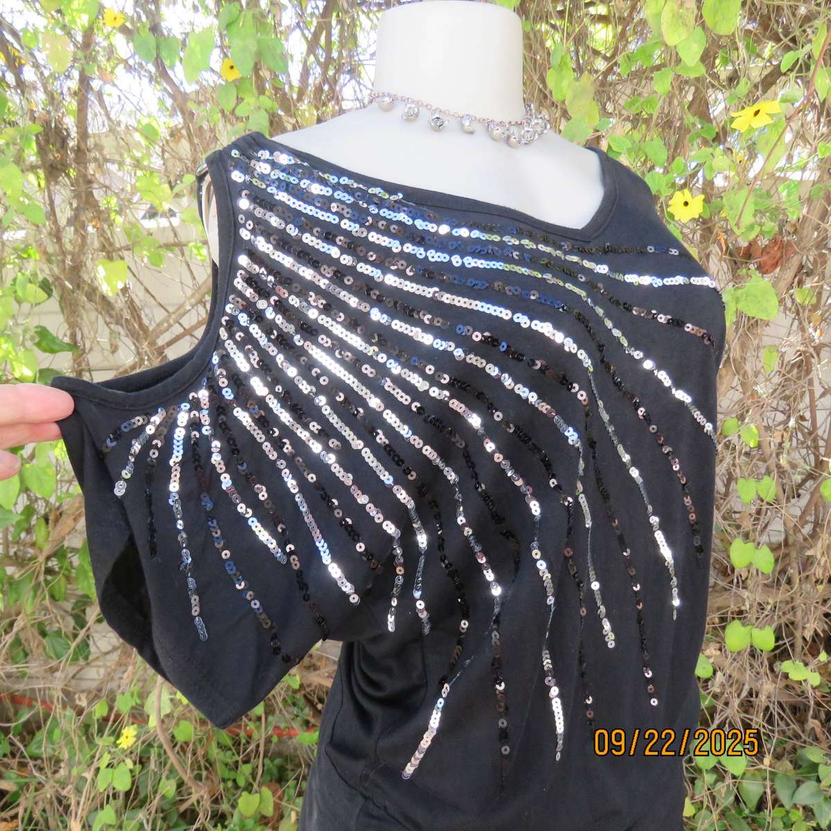 Black slip over glam top. Cut-on short sleeves. One open shoulder. Sequin decoration. Size 36
