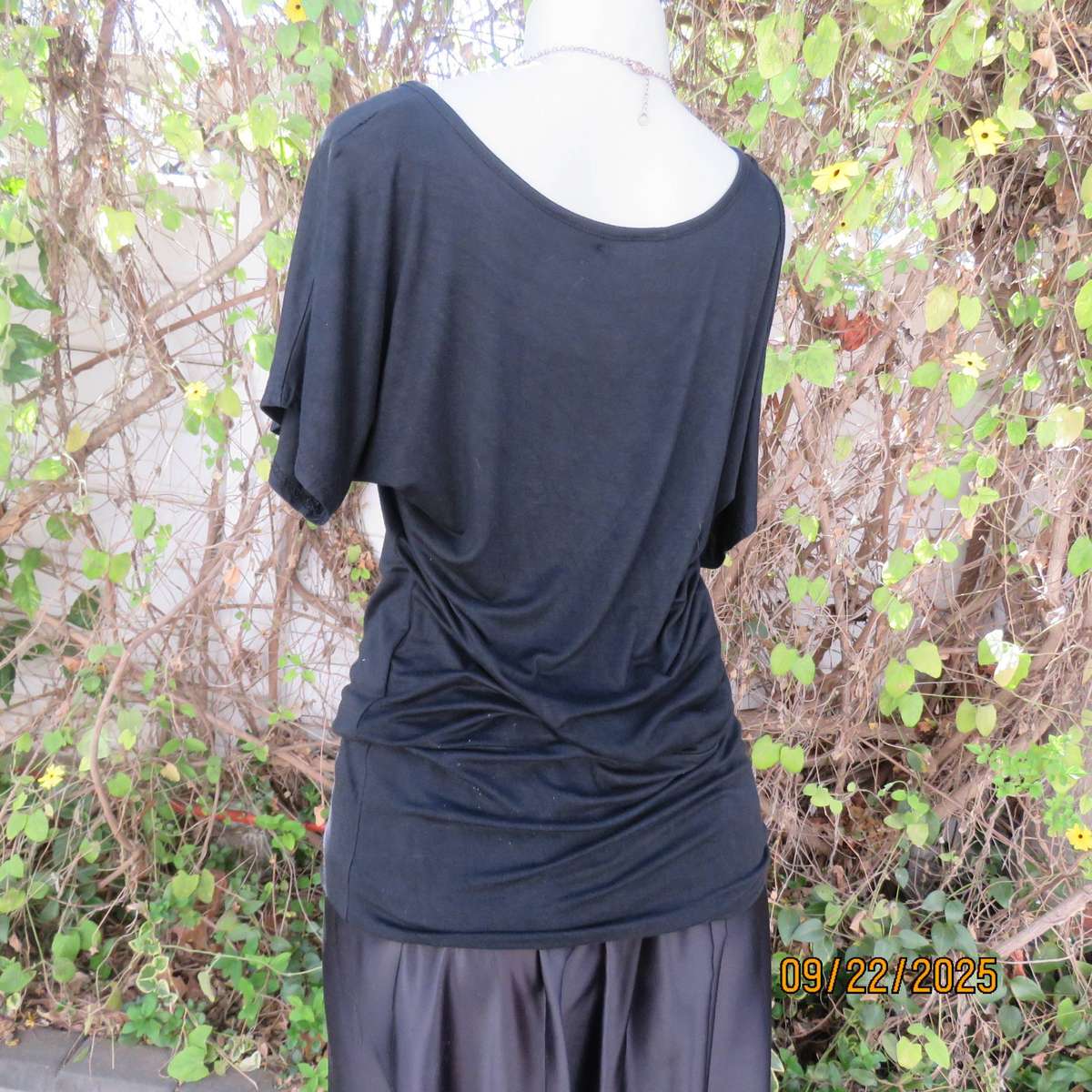 Black slip over glam top. Cut-on short sleeves. One open shoulder. Sequin decoration. Size 36