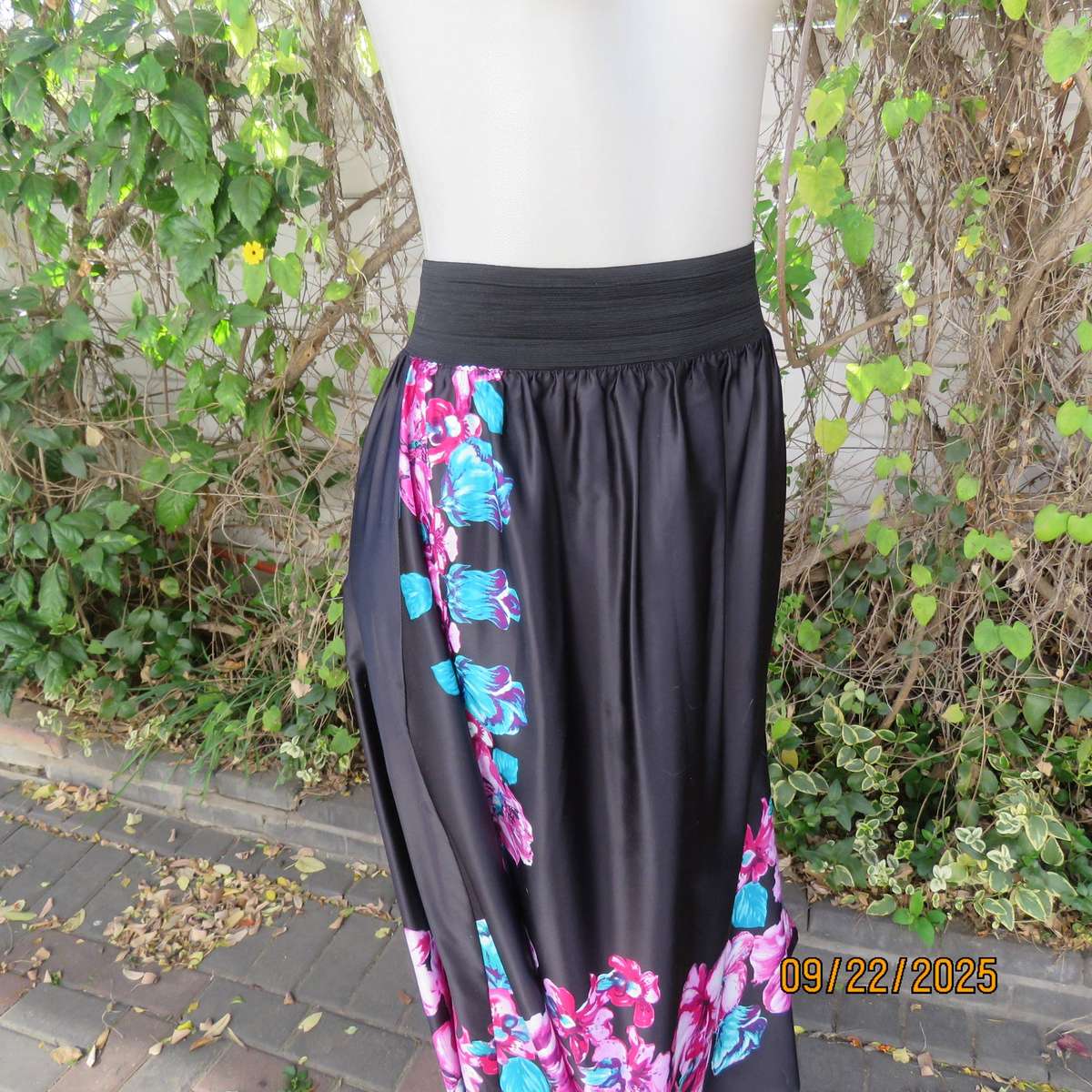 Black silky shiny polyester with pink-jade bold floral print maxi skirt. Elasticated waist. Size 42