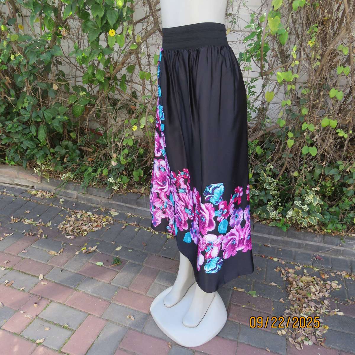 Black silky shiny polyester with pink-jade bold floral print maxi skirt. Elasticated waist. Size 42