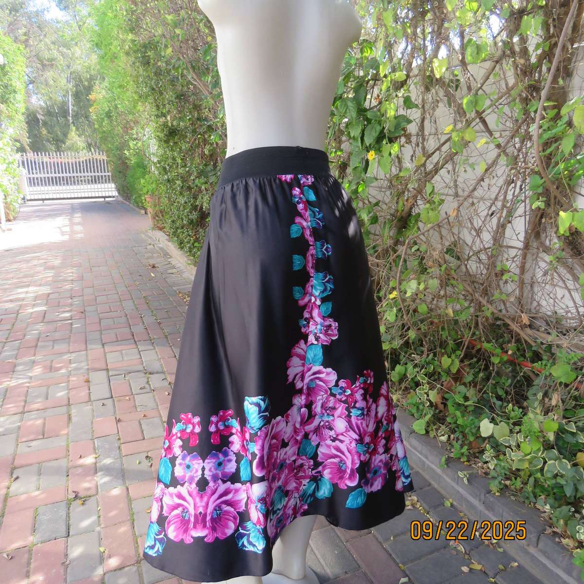 Black silky shiny polyester with pink-jade bold floral print maxi skirt. Elasticated waist. Size 42