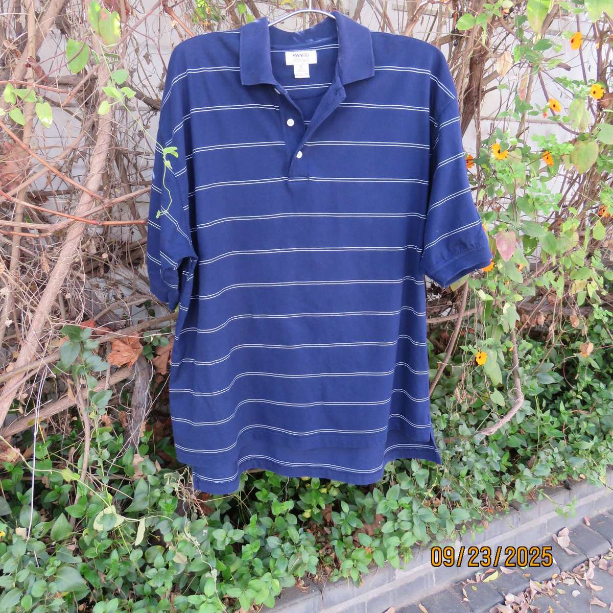 SWAGG navy with thin horizontal white stripe golf short sleeve shirt. Size XL.