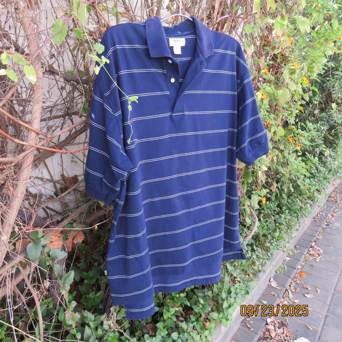 SWAGG navy with thin horizontal white stripe golf short sleeve shirt. Size XL.