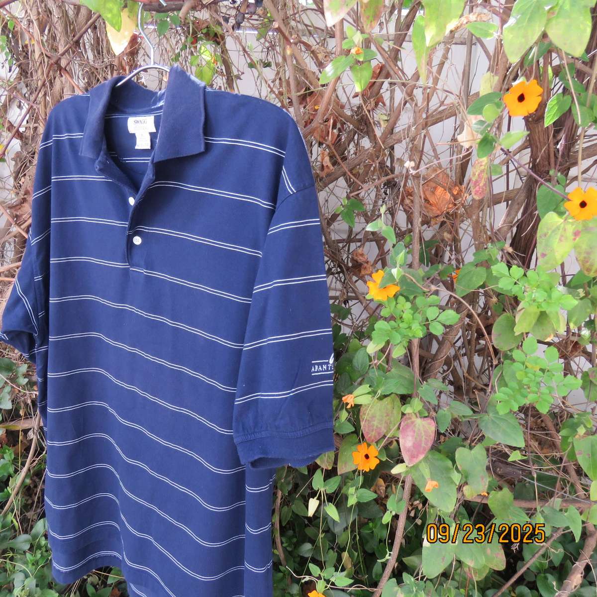 SWAGG navy with thin horizontal white stripe golf short sleeve shirt. Size XL.