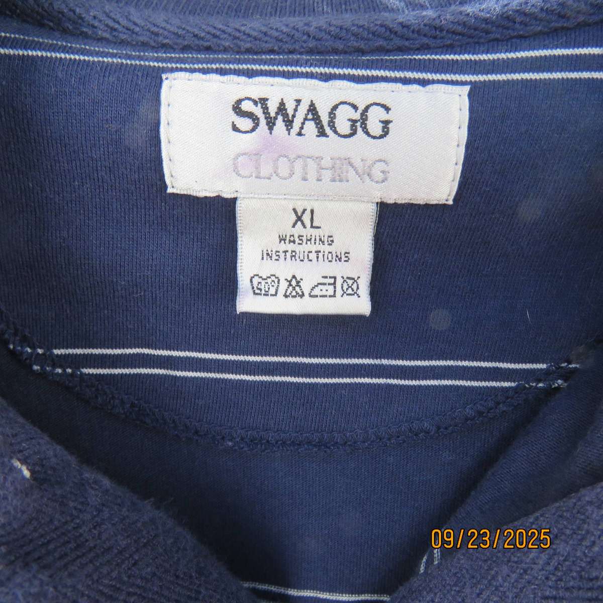 SWAGG navy with thin horizontal white stripe golf short sleeve shirt. Size XL.