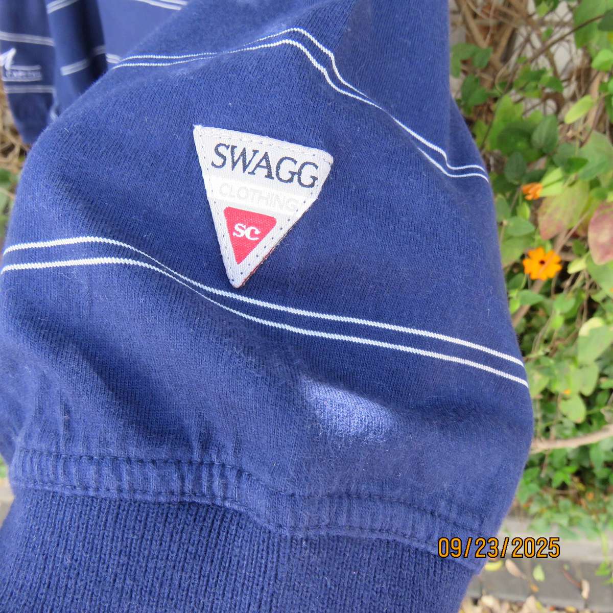 SWAGG navy with thin horizontal white stripe golf short sleeve shirt. Size XL.