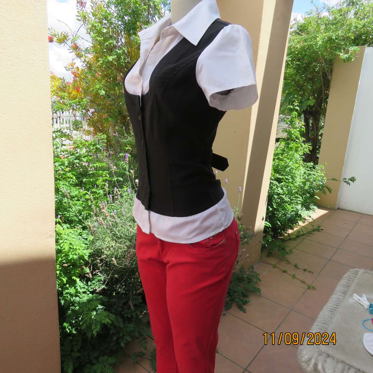 Timeless black stretch poly-rayon top with white polycotton capped sleeves and bib.Size 34.