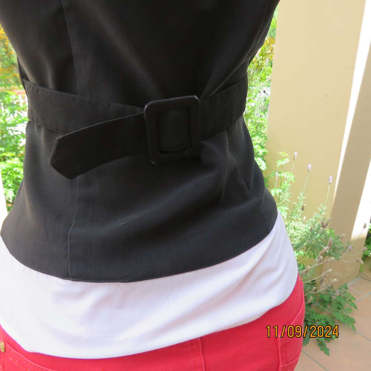 Timeless black stretch poly-rayon top with white polycotton capped sleeves and bib.Size 34.