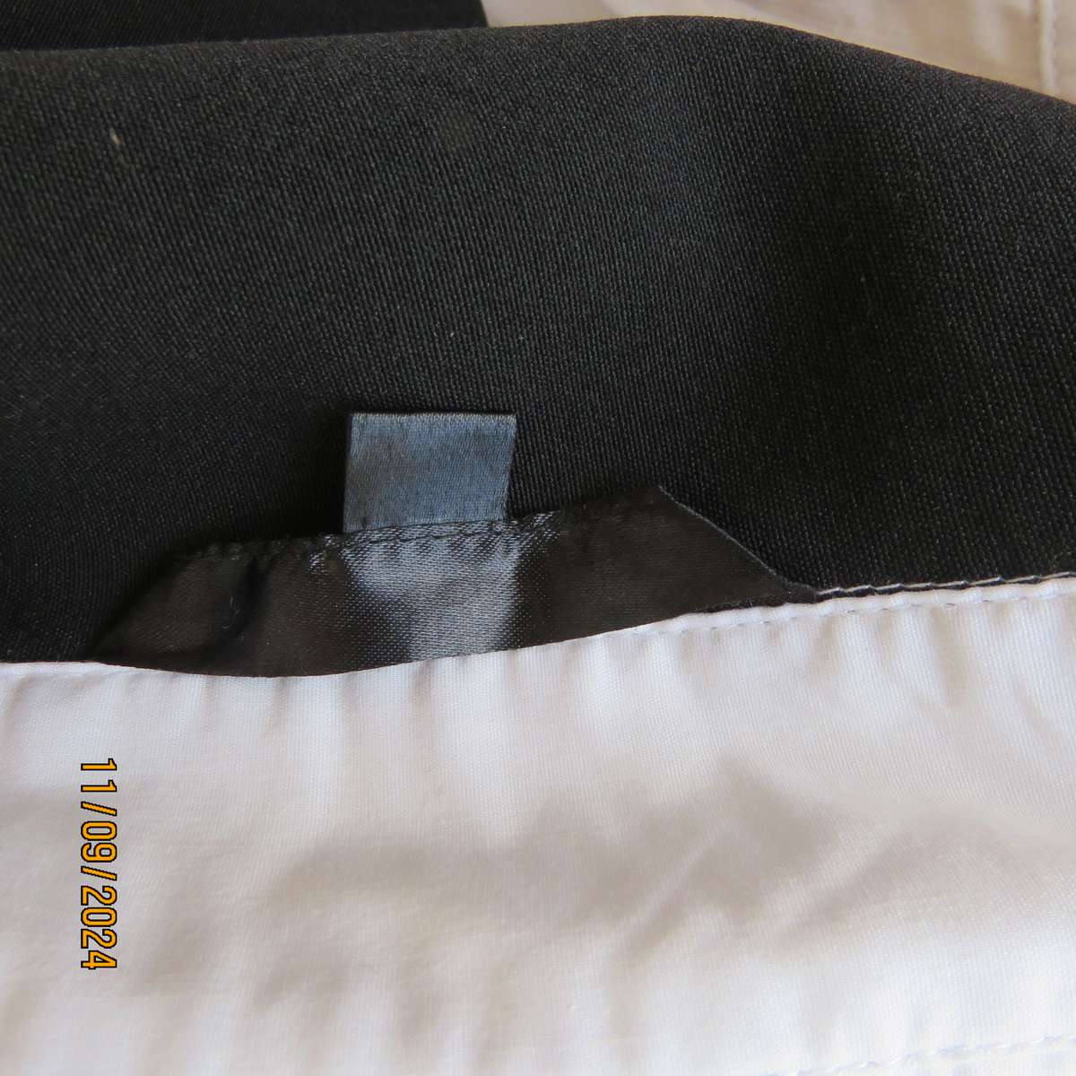 Timeless black stretch poly-rayon top with white polycotton capped sleeves and bib.Size 34.