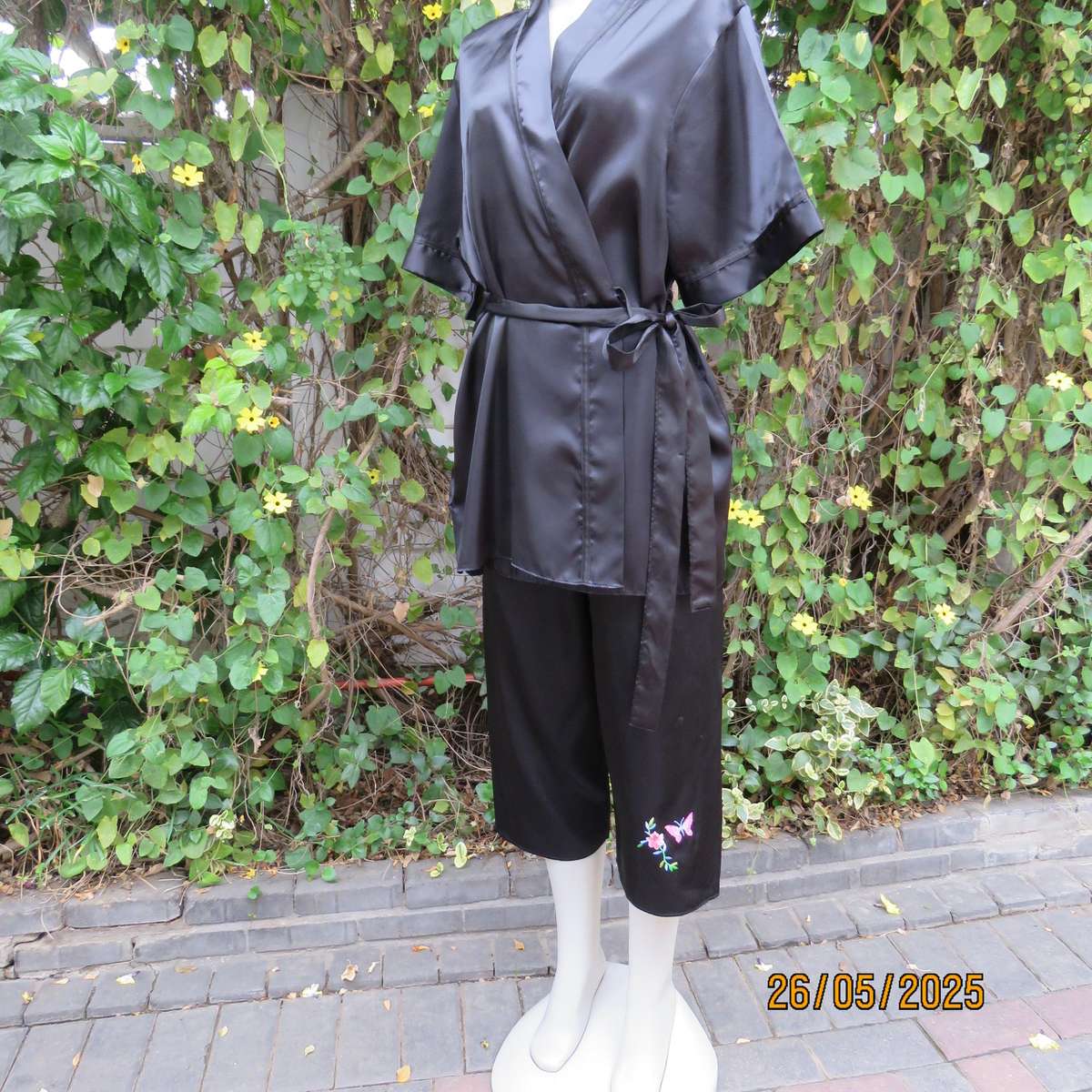 Black 2 pc satin polyester pajama set. Cropped pants-fold over top. Size 36-38