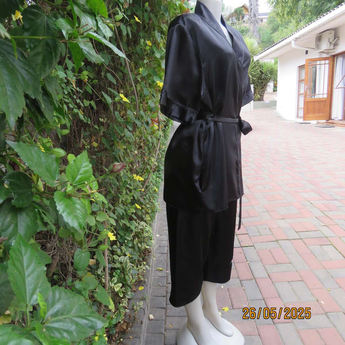 Black 2 pc satin polyester pajama set. Cropped pants-fold over top. Size 36-38