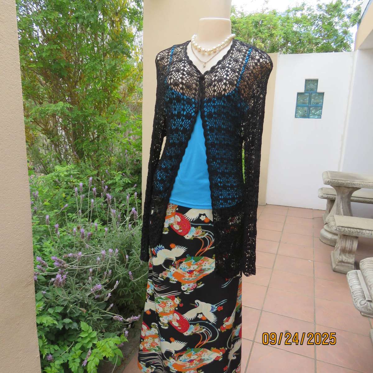 Black long sleeve poly-cotton crochet long cardigan. Four button closure. Size 34