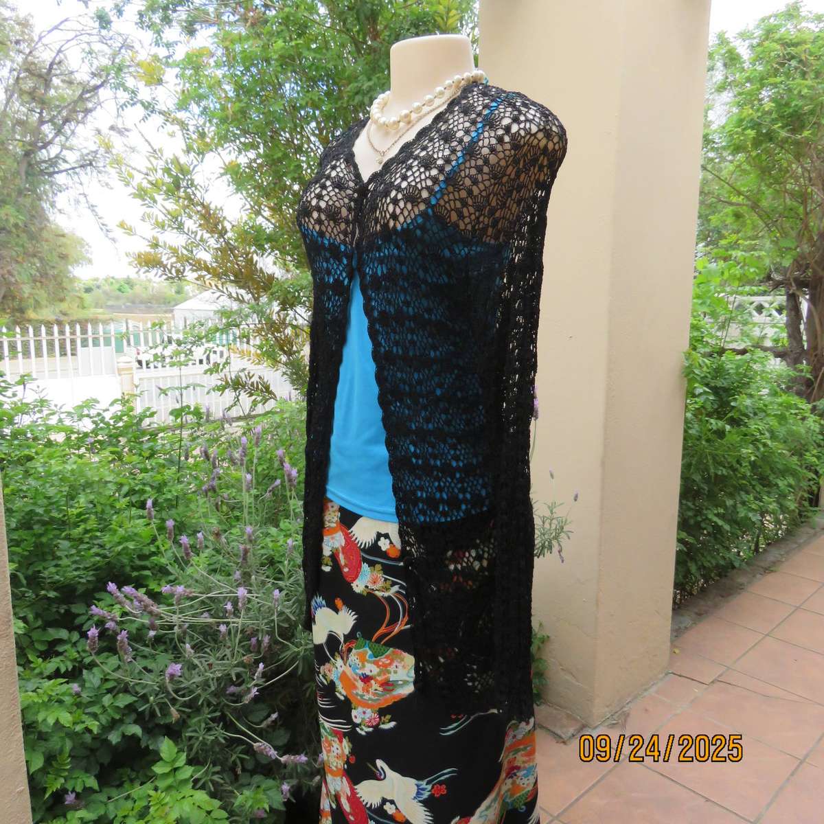 Black long sleeve poly-cotton crochet long cardigan. Four button closure. Size 34