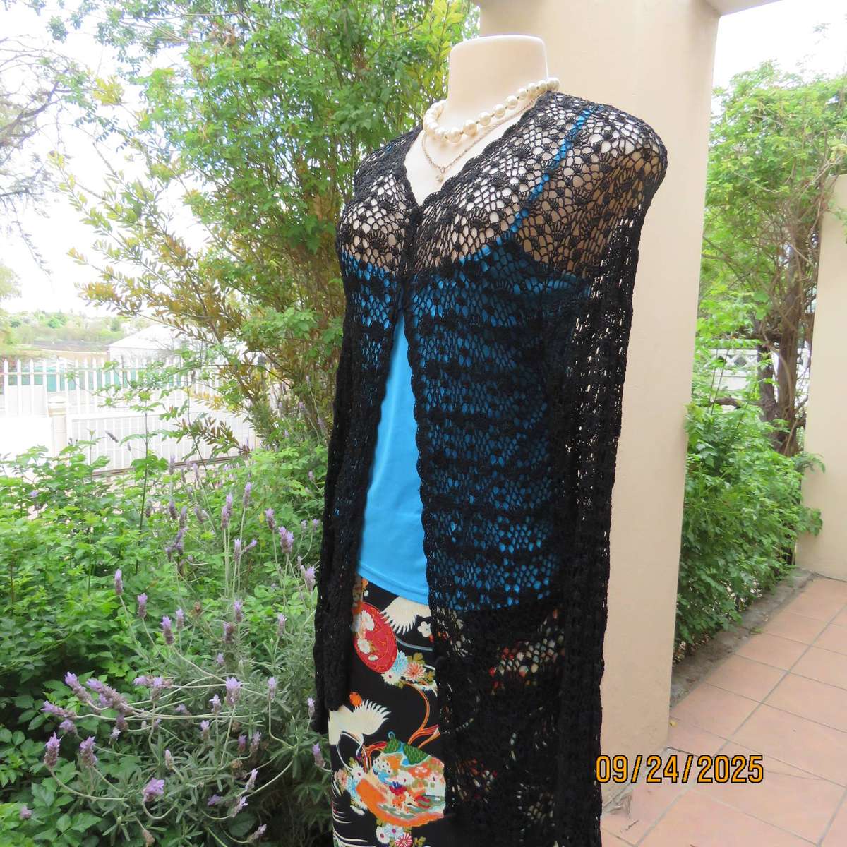 Black long sleeve poly-cotton crochet long cardigan. Four button closure. Size 34
