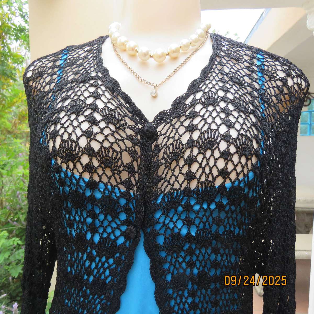 Black long sleeve poly-cotton crochet long cardigan. Four button closure. Size 34